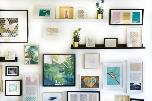 assortment of different types of framed art on a wall