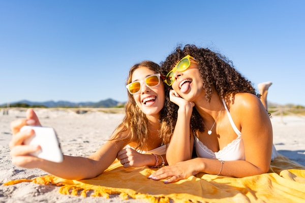 girls taking selfies at the beach