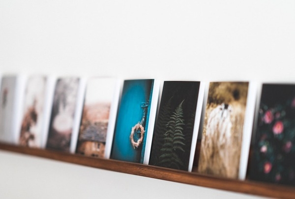 metal prints lined up on a wall shelf