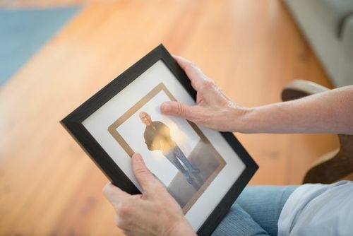 person holding a picture frame family