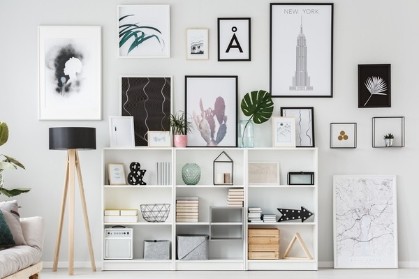 wall with different frames and cabinet storage compartments in white