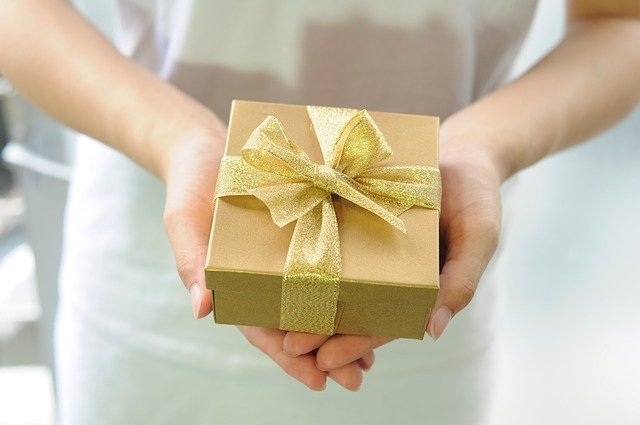 woman giving a gift for christmas